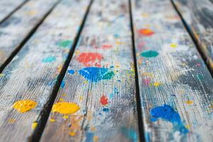 Colorful Paint Splashes On Rustic Wooden Planks With Weathered Texture For Artistic Background Design photo
