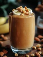 Creamy banana smoothie topped with nuts and bananas, refreshing drink for any time of the year. glass filled with a creamy peanut butter banana smoothie topped with sliced bananas and chopped nuts photo