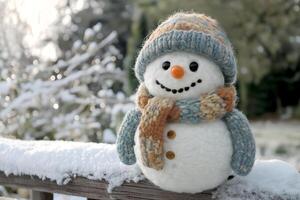 Cheerful snowman stands on a wooden railing covered in fresh snow during a winter morning in a serene outdoor setting. Cute snowman wearing a colorful knitted hat and scarf smiles brightly photo