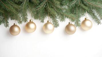 Elegant gold ornaments hanging from lush evergreen branches during the festive season. Golden ornaments dangle from fresh evergreen branches on white, Christmas and New Year background, copy space photo