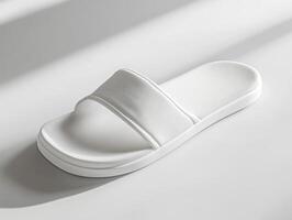 Stylish white slide sandal showcased on a minimalistic surface photo