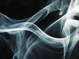 White smoke forms patterns on a dark background photo
