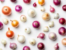 Colorful assortment of onions displayed on a white surface photo