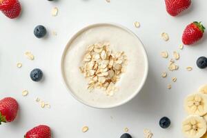 Healthy bowl of oatmeal topped with fresh fruits and nuts photo