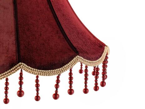 elegante rojo pantalla de lámpara con decorativo franja y rosario foto