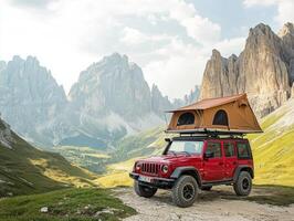 Red vehicle with rooftop tent parked in stunning mountain landscape photo