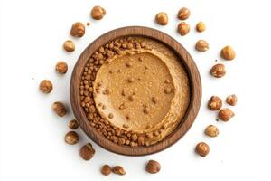 Delicious nut butter served in a wooden bowl with hazelnuts photo