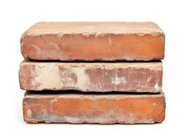 Stacked red bricks in a simple arrangement on white background photo
