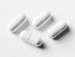 White capsules placed on a light surface in a simple arrangement photo