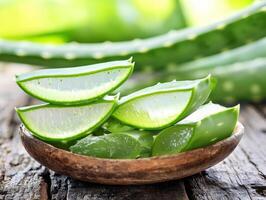 Fresh aloe vera slices arranged in a wooden bowl on a table photo