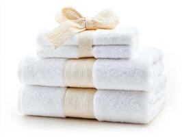 Soft white towels stacked neatly with a simple bow decoration photo