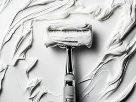 Shaving razor placed on creamy lather for grooming process photo
