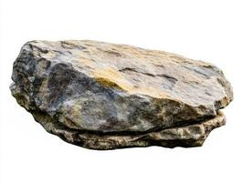 Natural stone formation resting on a flat surface outdoors photo