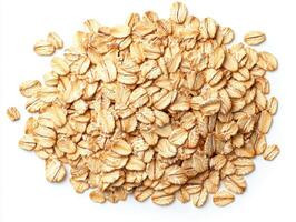 Oats pile on a white surface ready for cooking in a healthy meal photo