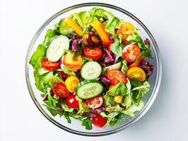 Colorful salad mix with fresh vegetables in a glass bowl photo