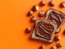 Delicious chocolate spread on whole grain bread with hazelnuts photo