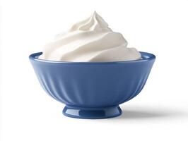 Delicious whipped cream in a blue bowl ready to enjoy photo
