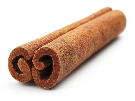 Cinnamon sticks resting on a white background for culinary use photo