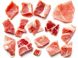 Freshly cut pork pieces arranged on a white background photo