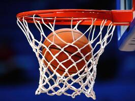 Basketball smoothly lands in the hoop during a competitive game photo