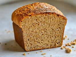 Freshly baked whole grain bread on a light surface photo