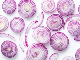 Sliced red onions arranged on a white surface photo