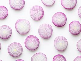 Sliced red onions arranged in a circular pattern on a white surface photo