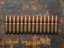 Bullets arranged neatly on a wooden surface at close range photo