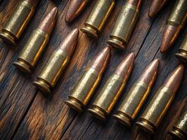Close-up view of ammunition arranged on a wooden surface photo