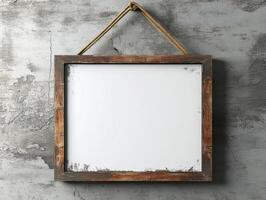 Rustic wooden frame hanging on a textured gray wall photo