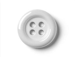 White button with four holes resting on a smooth surface photo