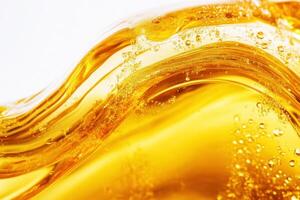 Golden liquid with bubbles flowing elegantly across a surface photo