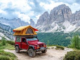 Adventure in the mountains with a red jeep and rooftop tent photo