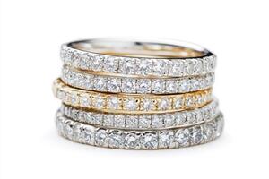 Elegant diamond rings stacked in gold and silver settings photo