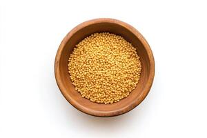 Mustard seeds in a wooden bowl on a white background photo