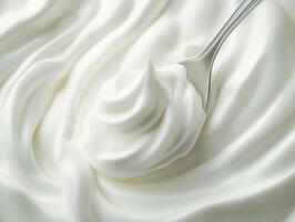 Creamy whipped topping swirled in a bowl with spoon photo