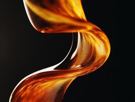 Golden syrup flows in elegant curves against a dark backdrop photo