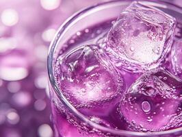 Purple drink with ice in a glass on a bright backdrop photo