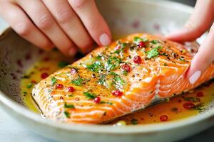 Preparing a salmon dish with herbs and spices in a bowl photo