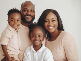 Happy family of four smiling together in a modern studio photo