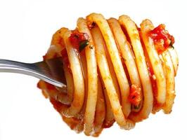 Delicious pasta twirled elegantly on a fork with marinara sauce photo