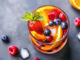 Refreshing fruit cocktail with berries and citrus garnishes photo