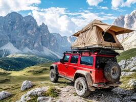 Camping in the mountains with a rooftop tent on a rugged vehicle photo