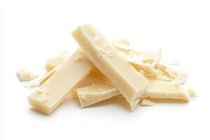 White chocolate pieces scattered on a clean surface photo