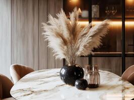 Modern dining table centerpiece with pampas grass and decorative vases photo