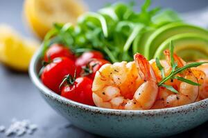 Delicious seafood salad featuring grilled shrimp, creamy avocado, and fresh cherry tomatoes for a refreshing meal. Mediterranean sea food salad with grilled shrimp, ripe avocado, tomatoes and arugula photo