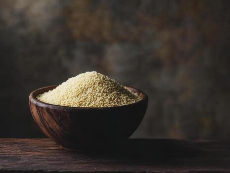 Couscous in a wooden bowl with a rustic background at home photo