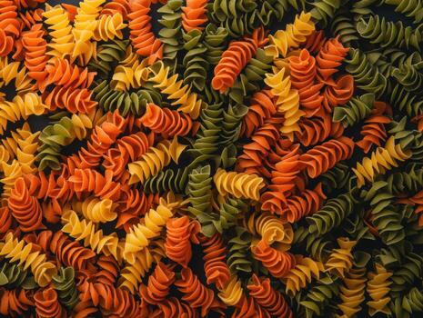 Colorful fusilli pasta arranged in a vibrant pattern photo