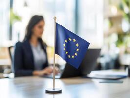European flag displayed in an office setting with a focused worker photo