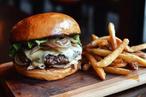 Juicy burger with melted cheese and crispy fries on wooden board photo